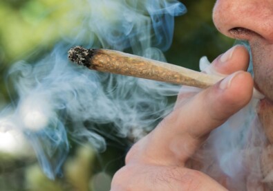 a man smoking a hemp pre-roll